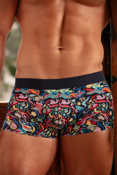 Colorful patterned underwear worn by a person with a blurred background